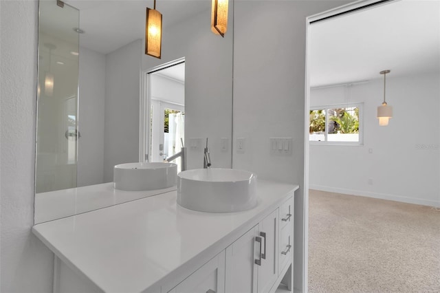 130 N Adams Dr, Sarasota, FL 34236 - bathroom with double vanity and baseboards