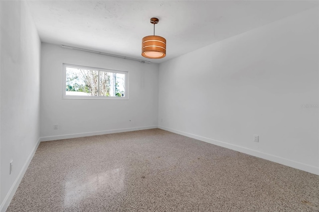 130 N Adams Dr, Sarasota, FL 34236 - empty room featuring speckle patterned floor and baseboards