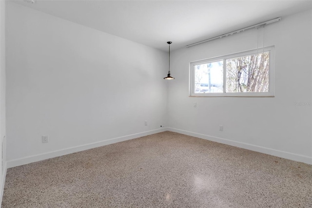 130 N Adams Dr, Sarasota, FL 34236 - empty room featuring baseboards and speckled floor