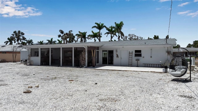 130 N Adams Dr, Sarasota, FL 34236 - back of property featuring a sunroom and a patio area