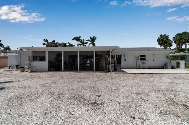 130 N Adams Dr, Sarasota, FL 34236 - rear view of house with a sunroom and a patio