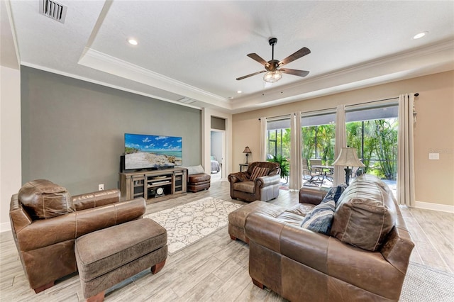 1219 Thornbury Dr, Parrish, FL 34219 - living area with a tray ceiling, light wood finished floors, ceiling fan, crown molding, and baseboards