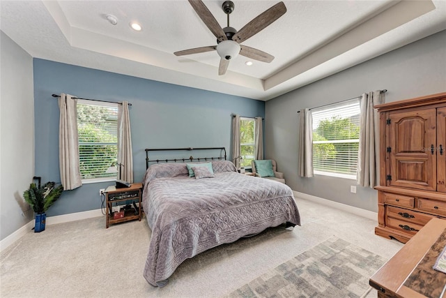 1219 Thornbury Dr, Parrish, FL 34219 - bedroom with light colored carpet, a tray ceiling, baseboards, and recessed lighting
