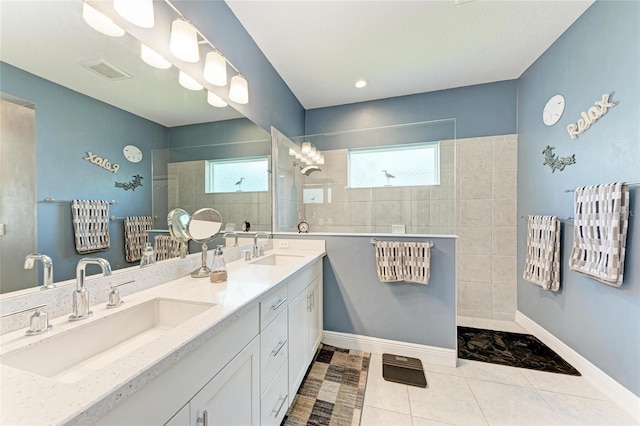 1219 Thornbury Dr, Parrish, FL 34219 - bathroom with a walk in shower, double vanity, baseboards, and tile patterned flooring