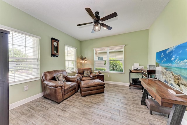 1219 Thornbury Dr, Parrish, FL 34219 - living area with ceiling fan, baseboards, and light wood-style floors