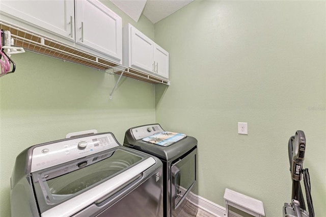 1219 Thornbury Dr, Parrish, FL 34219 - laundry area with cabinet space, washer and dryer, and baseboards