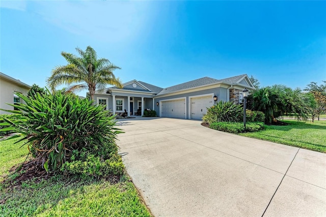 1219 Thornbury Dr, Parrish, FL 34219 - view of front of home featuring an attached garage, driveway, stucco siding, and a front yard