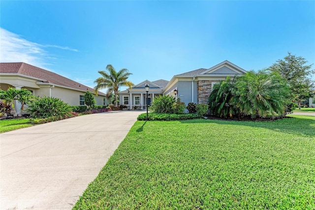 1219 Thornbury Dr, Parrish, FL 34219 - ranch-style home with driveway, a front lawn, stucco siding, and stone siding