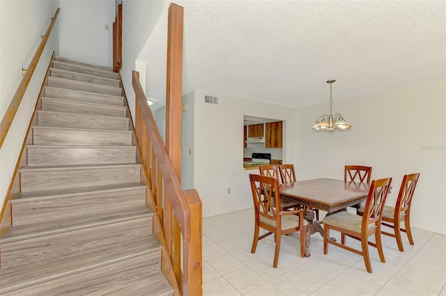 933 Sunridge Way Unit B5, Sarasota, FL 34234 - dining space featuring stairs, a chandelier, and a textured ceiling
