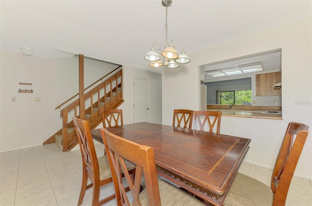 933 Sunridge Way Unit B5, Sarasota, FL 34234 - dining area featuring stairs, a chandelier, light tile patterned floors, and a textured ceiling