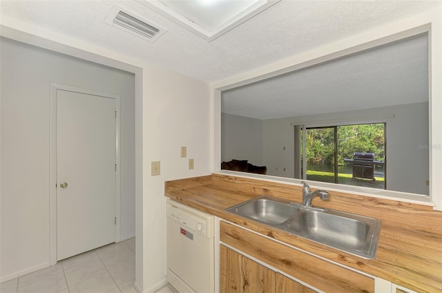 933 Sunridge Way Unit B5, Sarasota, FL 34234 - kitchen featuring white dishwasher, light tile patterned floors, and butcher block countertops
