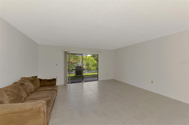 933 Sunridge Way Unit B5, Sarasota, FL 34234 - living room featuring a textured ceiling and light tile patterned floors