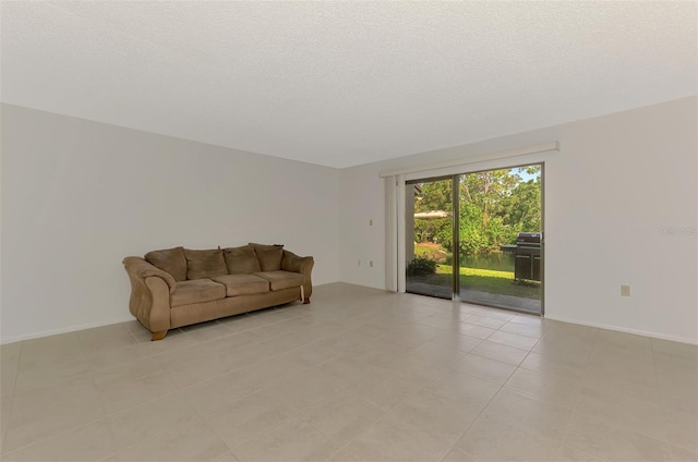 933 Sunridge Way Unit B5, Sarasota, FL 34234 - unfurnished living room featuring light tile patterned flooring and a textured ceiling