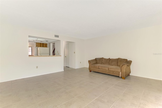 933 Sunridge Way Unit B5, Sarasota, FL 34234 - living area featuring light tile patterned floors and stairs