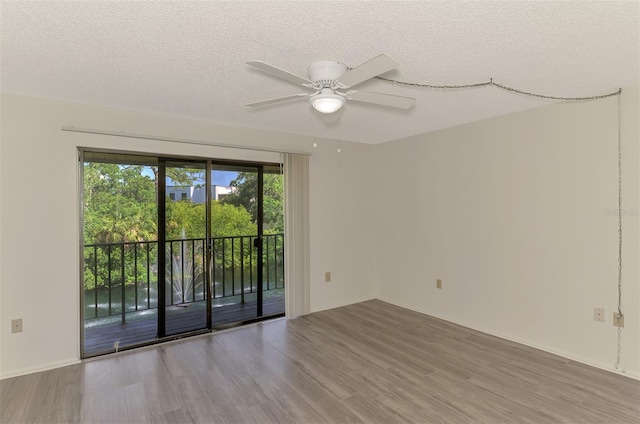 933 Sunridge Way Unit B5, Sarasota, FL 34234 - empty room featuring wood finished floors, a ceiling fan, and a textured ceiling