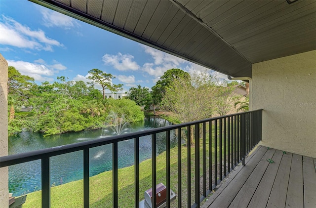 933 Sunridge Way Unit B5, Sarasota, FL 34234 - balcony featuring a water view, a grill, and view of scattered trees