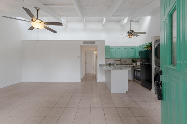 500 N Jefferson Ave Unit G5, Sarasota, FL 34237 - kitchen featuring ceiling fan, a peninsula, light countertops, a towering ceiling, and open floor plan