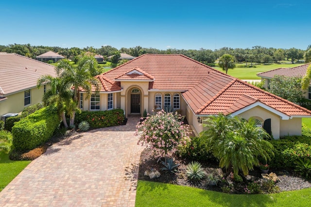 9719 Discovery Ter, Bradenton, FL 34212 - mediterranean / spanish home with a tile roof, stucco siding, and decorative driveway