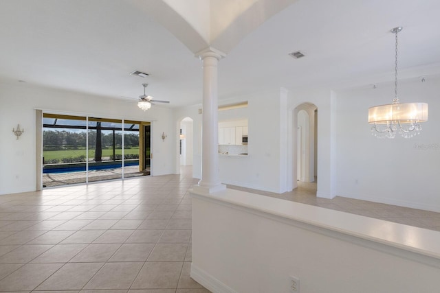 9719 Discovery Ter, Bradenton, FL 34212 - spare room featuring arched walkways, light tile patterned floors, ceiling fan, a chandelier, and ornate columns