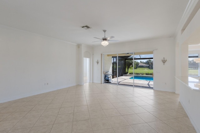 9719 Discovery Ter, Bradenton, FL 34212 - unfurnished room featuring crown molding, ceiling fan, light tile patterned flooring, and arched walkways