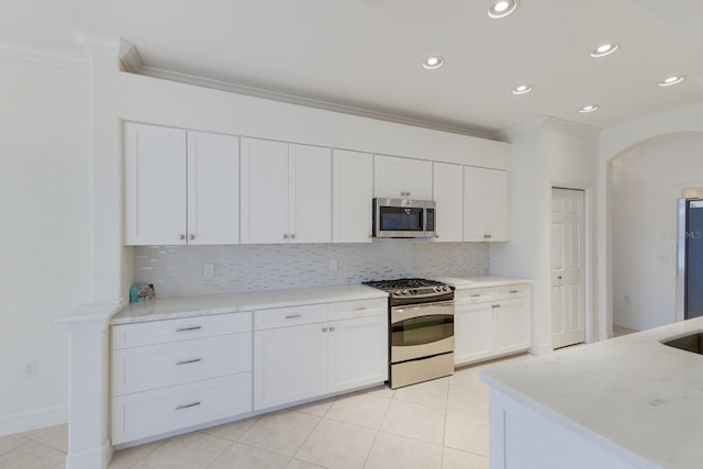 9719 Discovery Ter, Bradenton, FL 34212 - kitchen with appliances with stainless steel finishes, ornamental molding, tasteful backsplash, white cabinetry, and recessed lighting