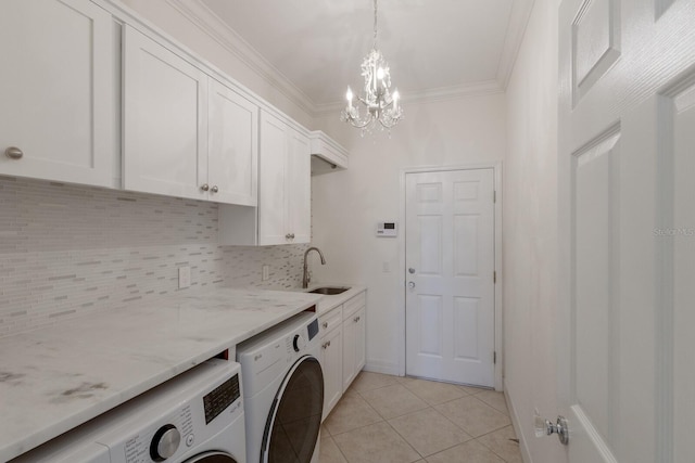 9719 Discovery Ter, Bradenton, FL 34212 - washroom with washer and dryer, cabinet space, crown molding, a chandelier, and light tile patterned flooring