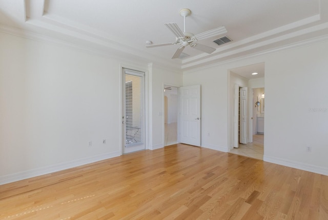 9719 Discovery Ter, Bradenton, FL 34212 - unfurnished room featuring a tray ceiling, light wood-style floors, ceiling fan, and crown molding
