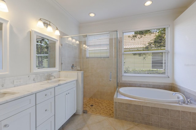 9719 Discovery Ter, Bradenton, FL 34212 - bathroom with tile patterned flooring, double vanity, a stall shower, a bath, and ornamental molding