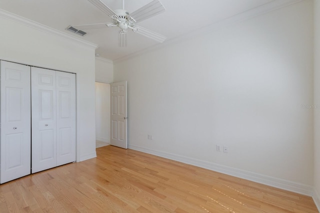 9719 Discovery Ter, Bradenton, FL 34212 - unfurnished bedroom featuring crown molding, light wood-style flooring, a closet, and a ceiling fan