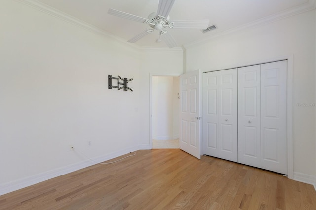9719 Discovery Ter, Bradenton, FL 34212 - unfurnished bedroom featuring crown molding, light wood finished floors, a closet, and ceiling fan