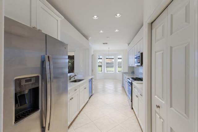 9719 Discovery Ter, Bradenton, FL 34212 - kitchen with stainless steel appliances, light countertops, recessed lighting, white cabinetry, and light tile patterned flooring