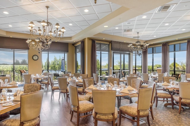 9719 Discovery Ter, Bradenton, FL 34212 - dining room featuring a chandelier, a paneled ceiling, and wood finished floors