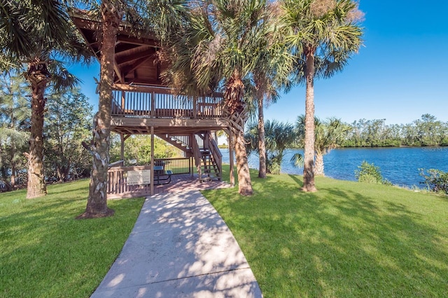 9719 Discovery Ter, Bradenton, FL 34212 - view of community featuring a yard, a deck with water view, stairs, and a patio area