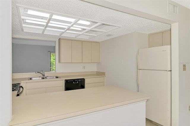 935 Sunridge Way Unit B4, Sarasota, FL 34234 - kitchen featuring freestanding refrigerator, black dishwasher, cream cabinets, a peninsula, and light countertops