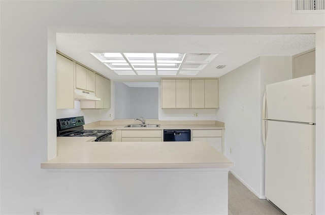 935 Sunridge Way Unit B4, Sarasota, FL 34234 - kitchen with black appliances, under cabinet range hood, cream cabinets, and light countertops