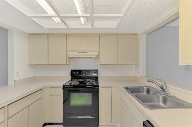 935 Sunridge Way Unit B4, Sarasota, FL 34234 - kitchen featuring cream cabinetry, under cabinet range hood, black electric range oven, and light countertops