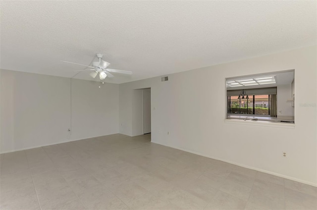 935 Sunridge Way Unit B4, Sarasota, FL 34234 - spare room with a ceiling fan and a textured ceiling