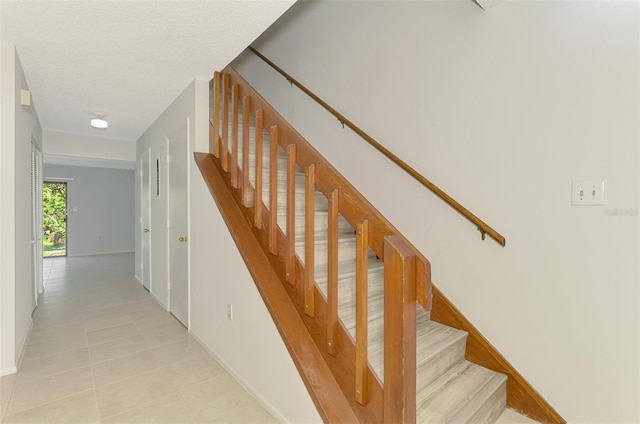 935 Sunridge Way Unit B4, Sarasota, FL 34234 - stairs with tile patterned flooring and a textured ceiling