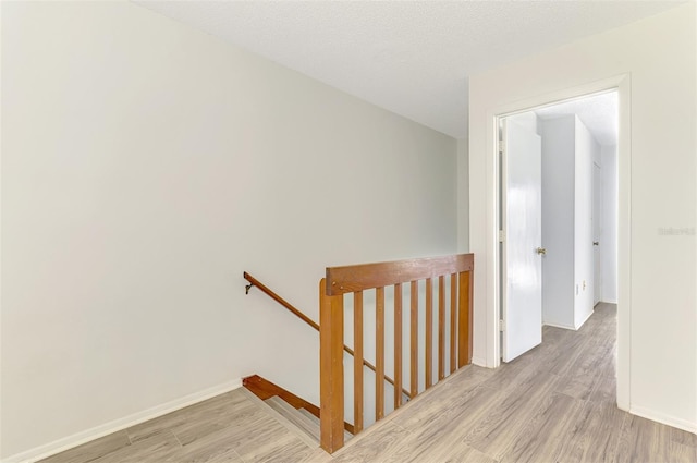 935 Sunridge Way Unit B4, Sarasota, FL 34234 - hall featuring an upstairs landing and wood finished floors