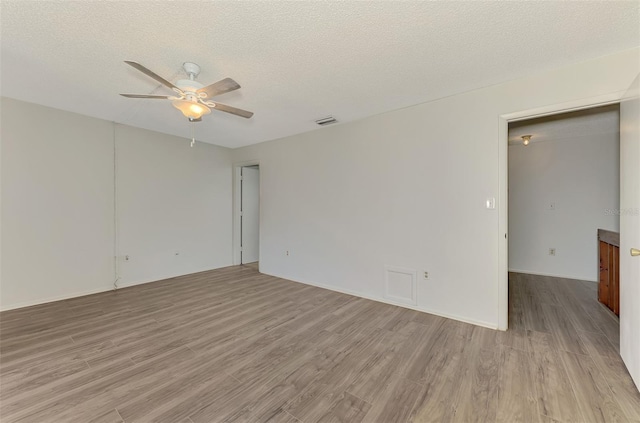 935 Sunridge Way Unit B4, Sarasota, FL 34234 - unfurnished room with ceiling fan, wood finished floors, and a textured ceiling