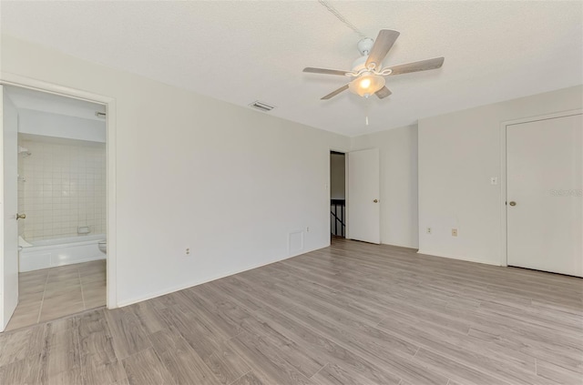 935 Sunridge Way Unit B4, Sarasota, FL 34234 - unfurnished bedroom with light wood-style flooring, connected bathroom, and a ceiling fan
