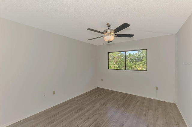 935 Sunridge Way Unit B4, Sarasota, FL 34234 - unfurnished room featuring light wood-type flooring, a ceiling fan, and a textured ceiling