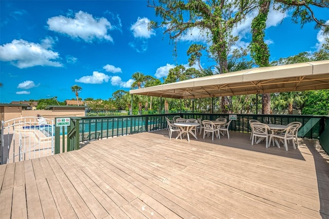 935 Sunridge Way Unit B4, Sarasota, FL 34234 - wooden terrace featuring outdoor dining area, a gazebo, and a pool
