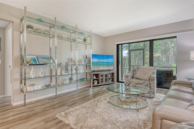 2055 Gulf Of Mexico Dr Unit G2-108, Longboat Key, FL 34228 - living area featuring wood finished floors and baseboards