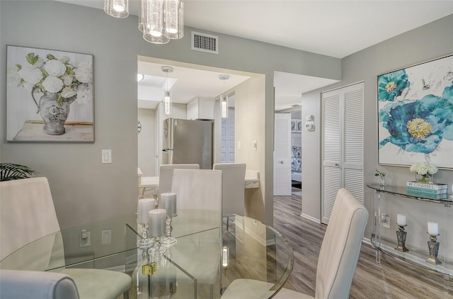 2055 Gulf Of Mexico Dr Unit G2-108, Longboat Key, FL 34228 - dining room with wood finished floors and baseboards