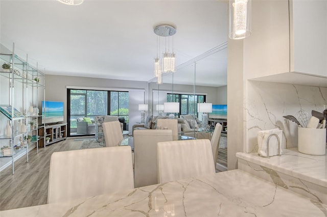 2055 Gulf Of Mexico Dr Unit G2-108, Longboat Key, FL 34228 - dining space with wood finished floors and a chandelier