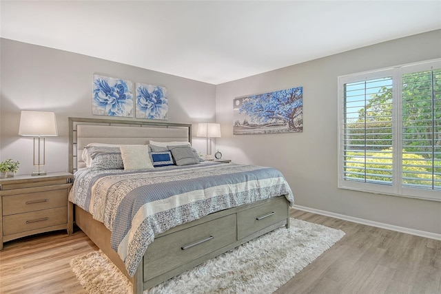 2055 Gulf Of Mexico Dr Unit G2-108, Longboat Key, FL 34228 - bedroom featuring light wood-style flooring and baseboards