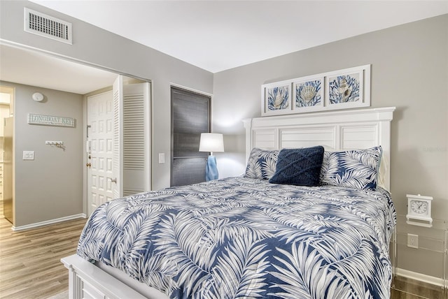 2055 Gulf Of Mexico Dr Unit G2-108, Longboat Key, FL 34228 - bedroom featuring wood finished floors and a closet