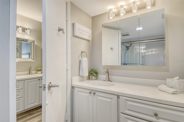 2055 Gulf Of Mexico Dr Unit G2-108, Longboat Key, FL 34228 - bathroom featuring vanity, a shower stall, and wood finished floors