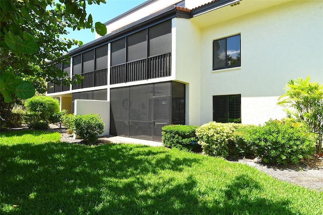 2055 Gulf Of Mexico Dr Unit G2-108, Longboat Key, FL 34228 - back of house featuring stucco siding and a yard